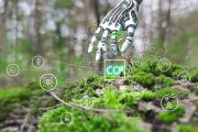 Ilustrační fotografie ruky robota v lese a ikonou co2