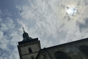 Věž kostela Nanebevzetí Panny Marie v Mostě nad kterou létá dron